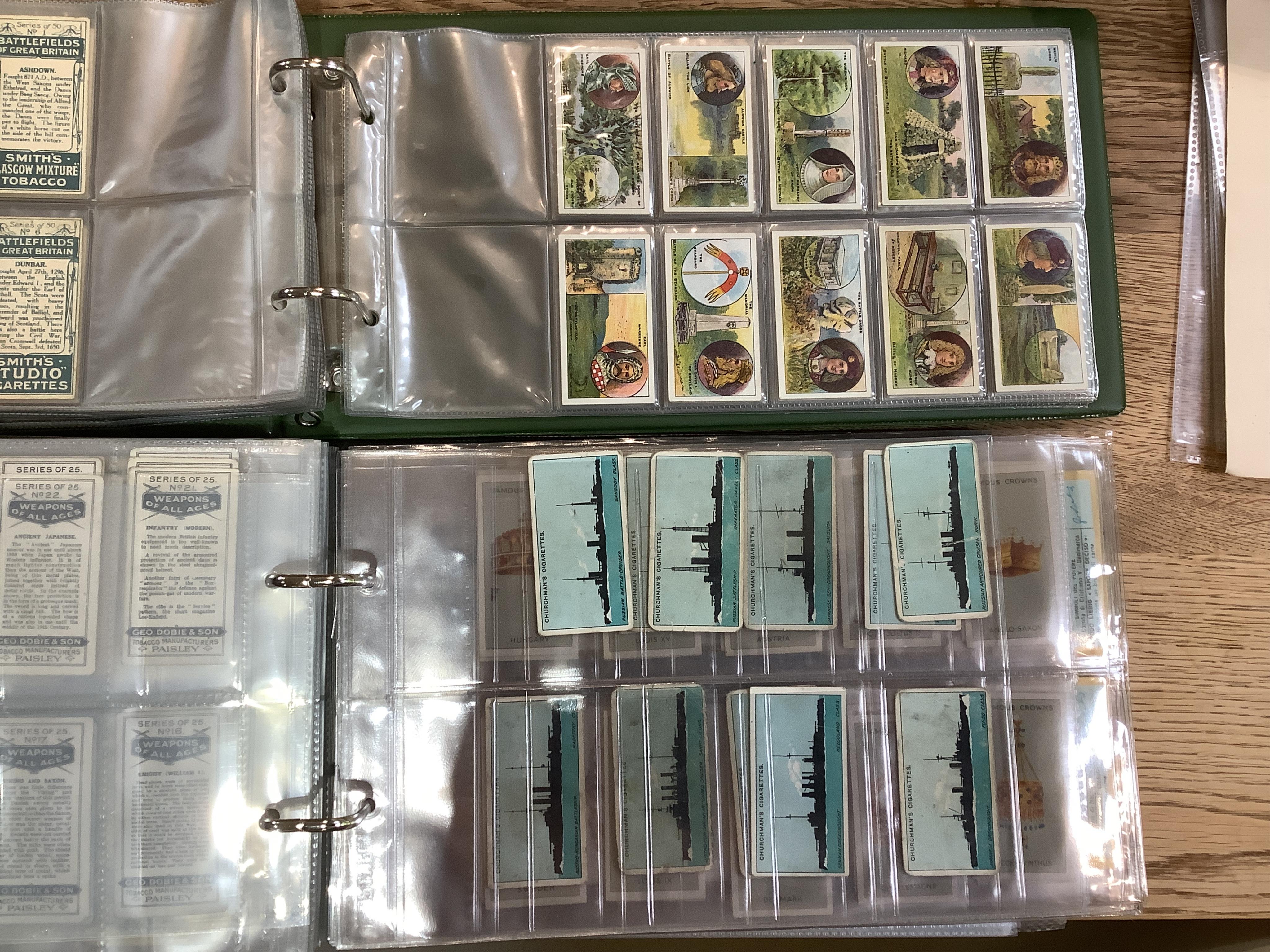 Four albums of assorted cigarette cards; military badges, heroes, soldiers and war, and some loose silks.